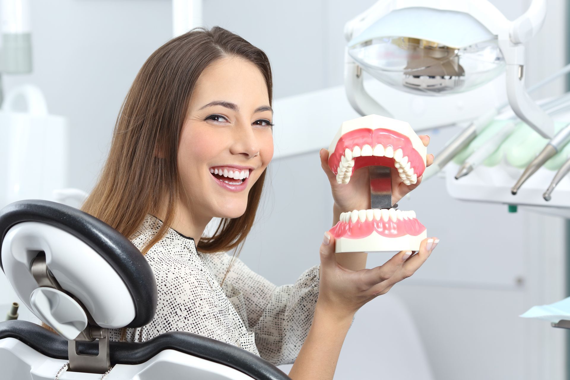 An Implant Dentistry patient smiling with a plastic denture.