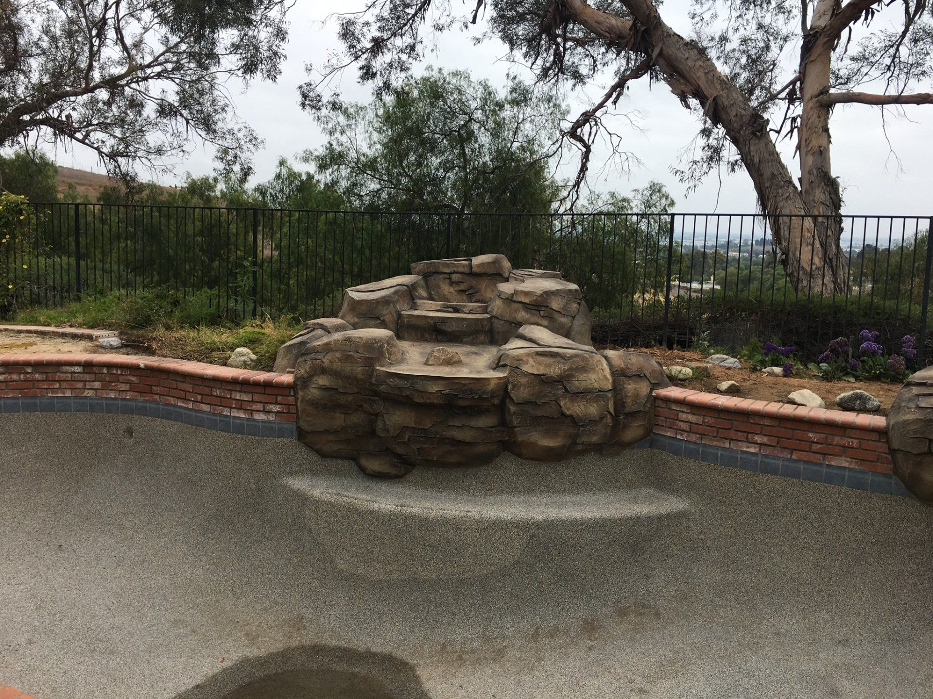 A pool with a waterfall in the middle of it