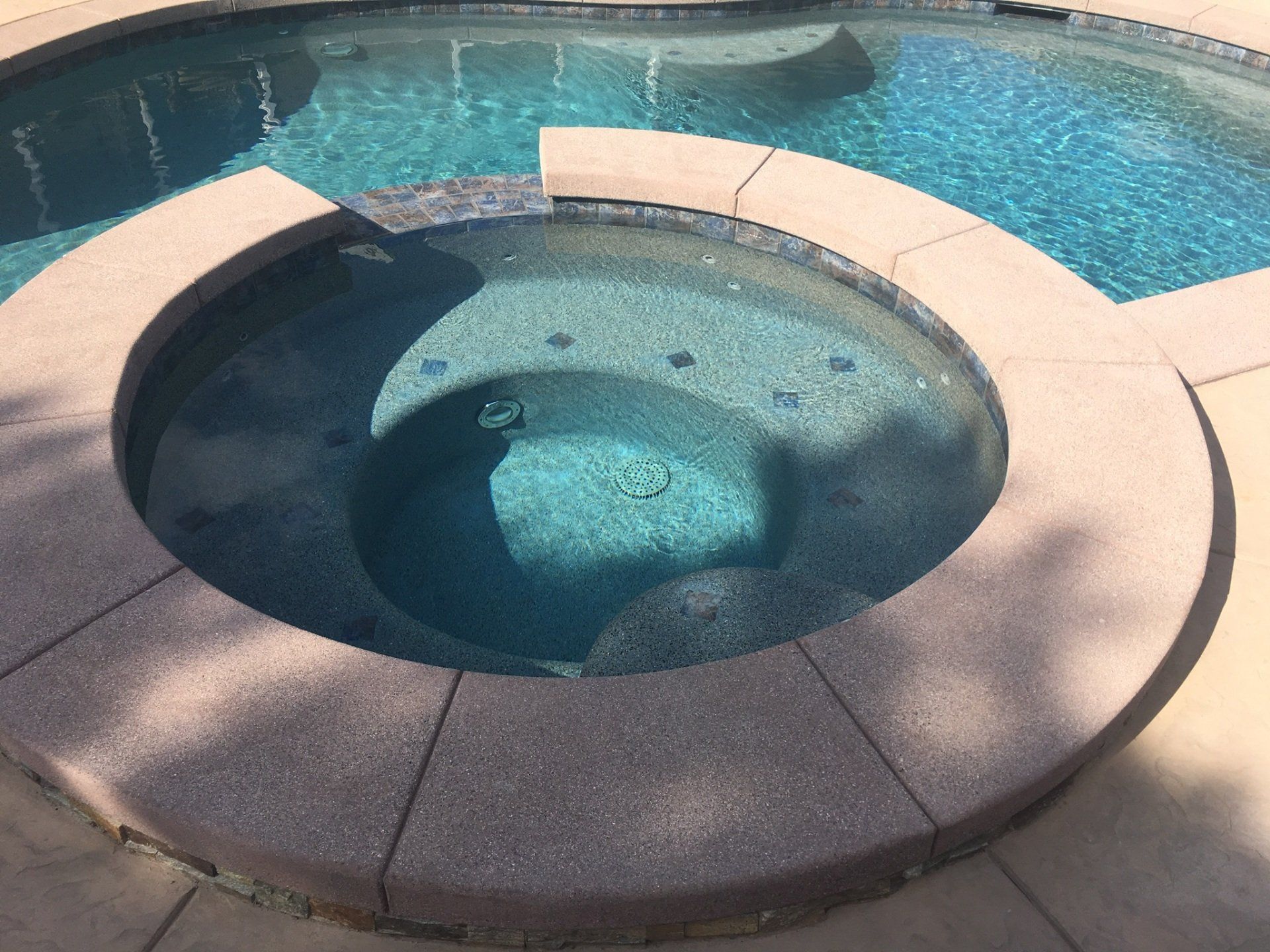 A hot tub in the middle of a swimming pool