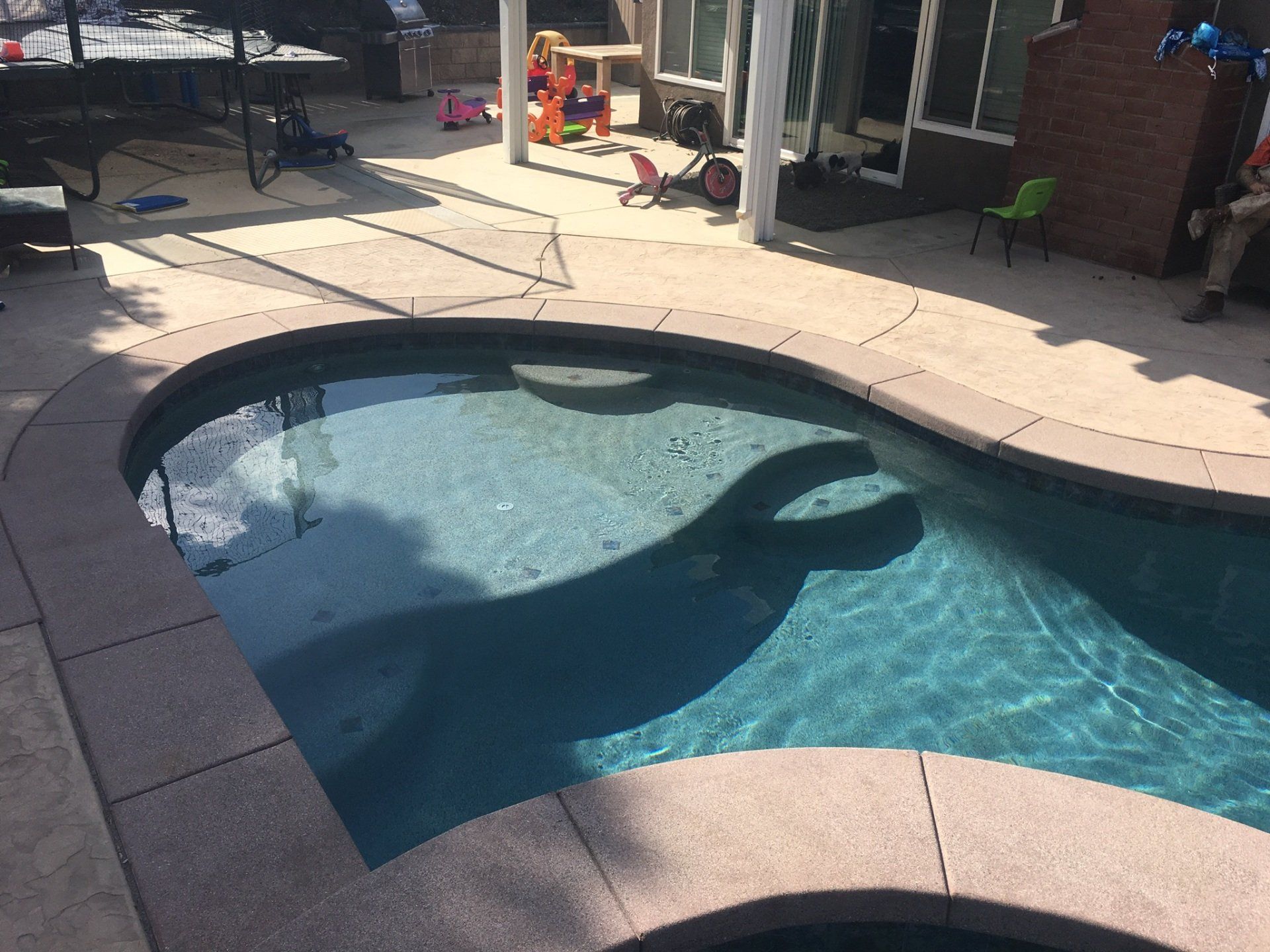 A large swimming pool with a shadow of a person in it