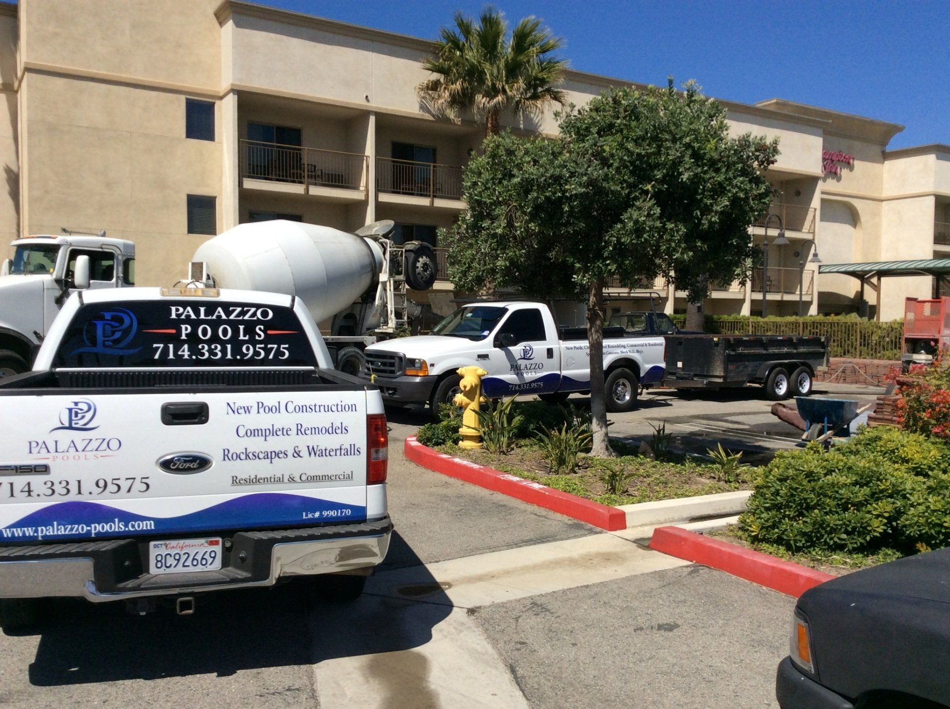 A palazzo concrete truck is parked in front of a building