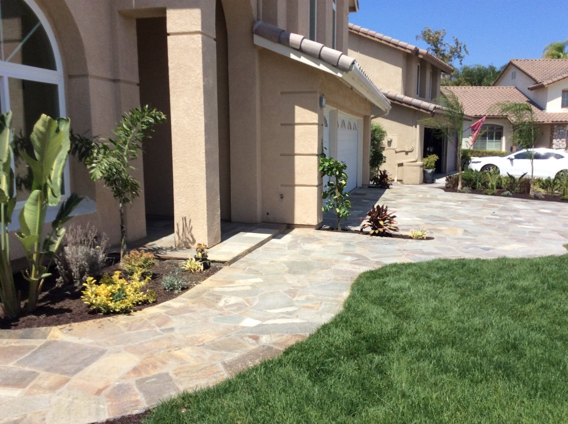 A house with a stone walkway leading to the front door