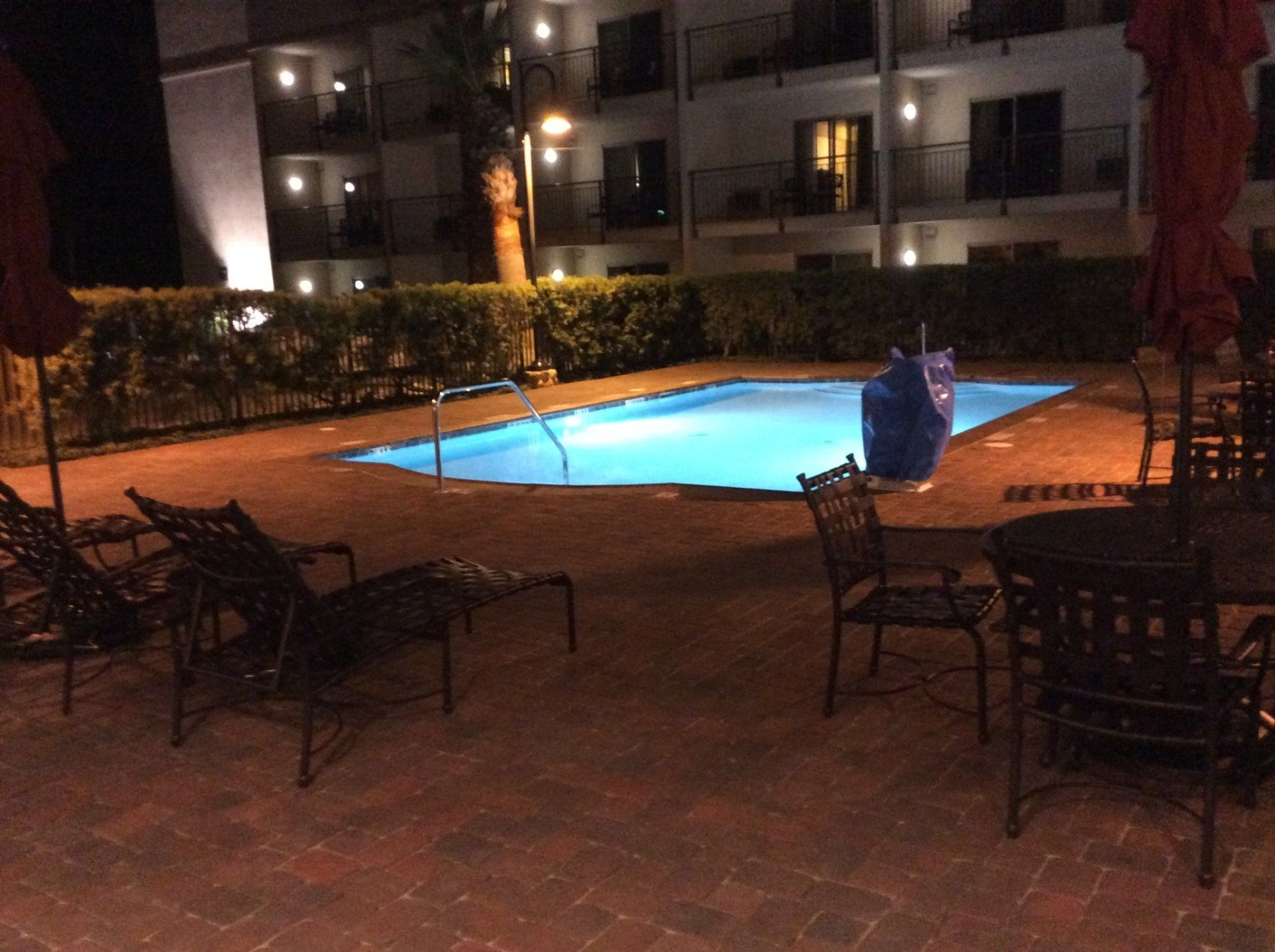 A large swimming pool is lit up at night