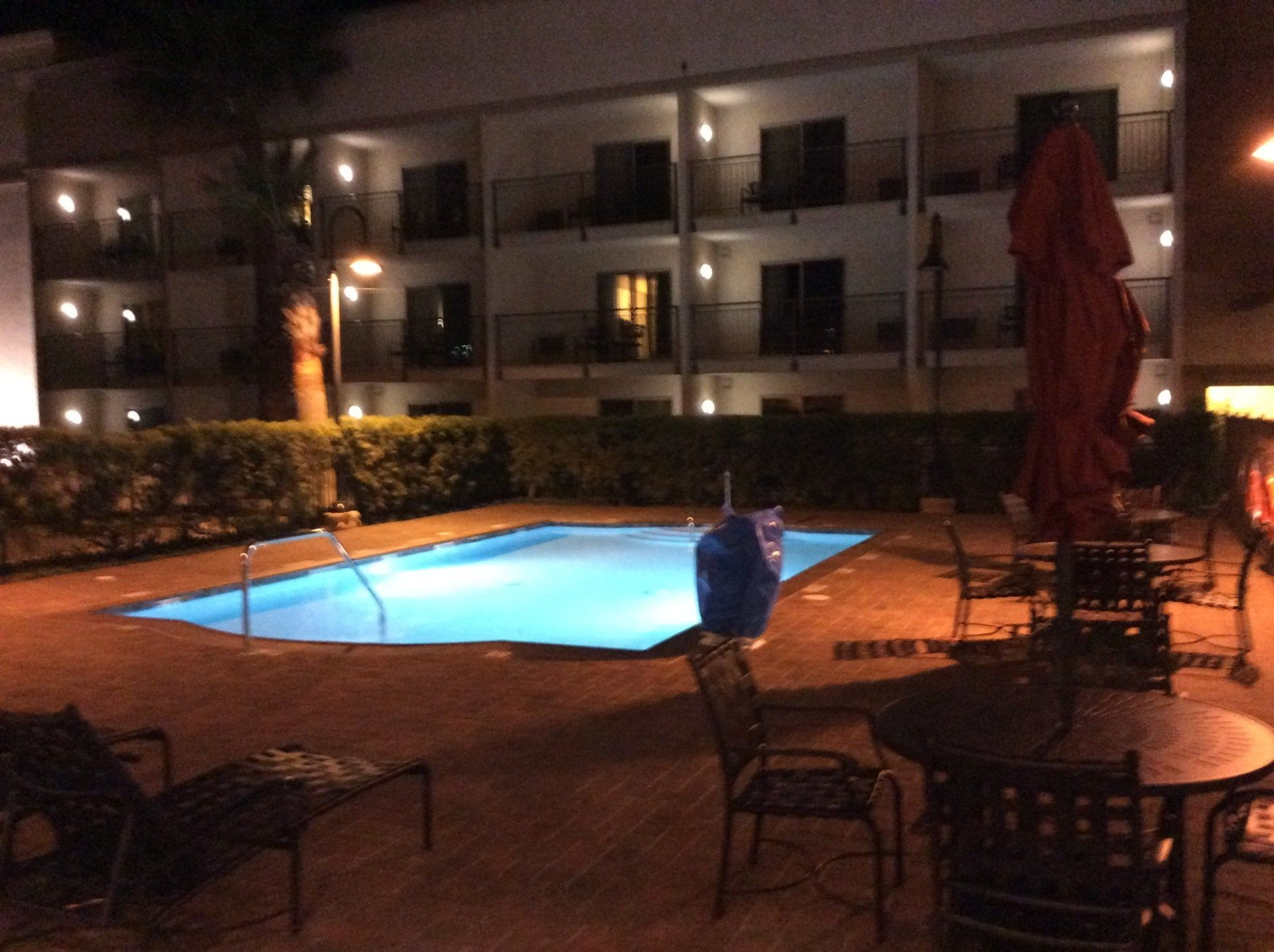 A large swimming pool is lit up at night