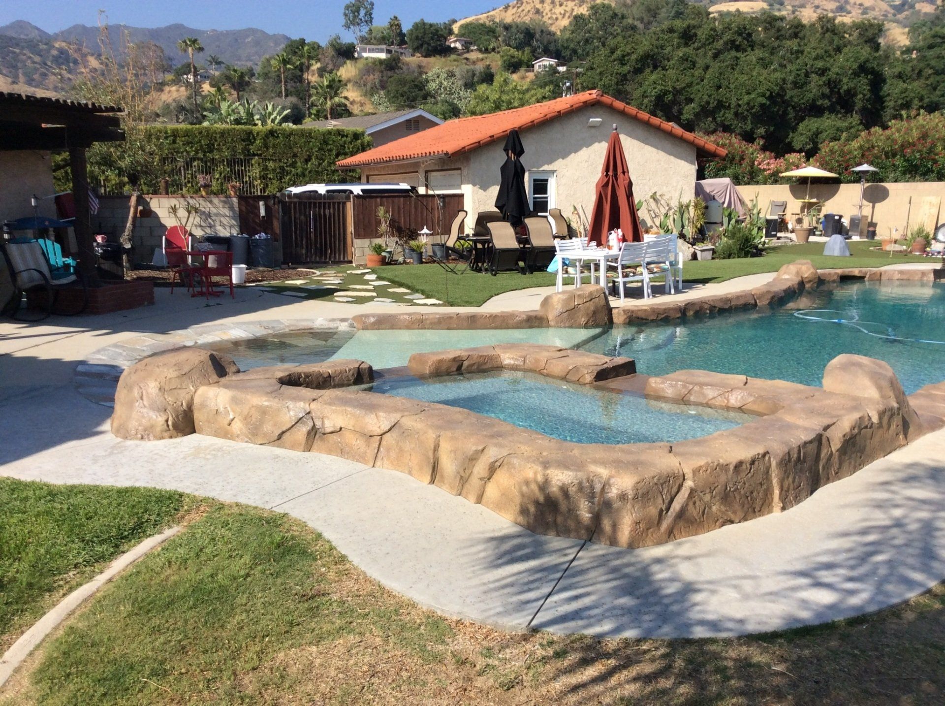 A large swimming pool in the backyard of a house