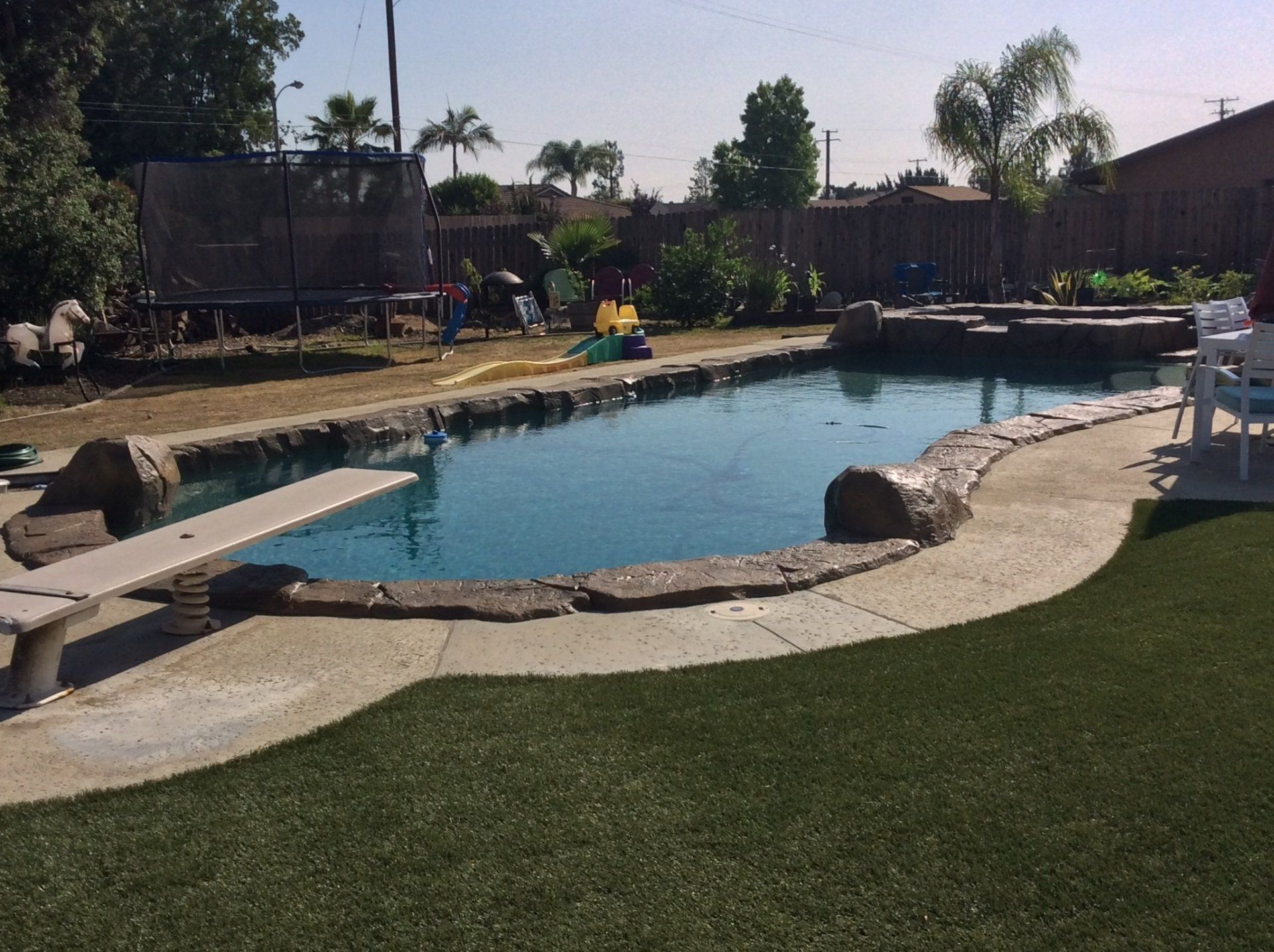 A large swimming pool with a diving board in the middle