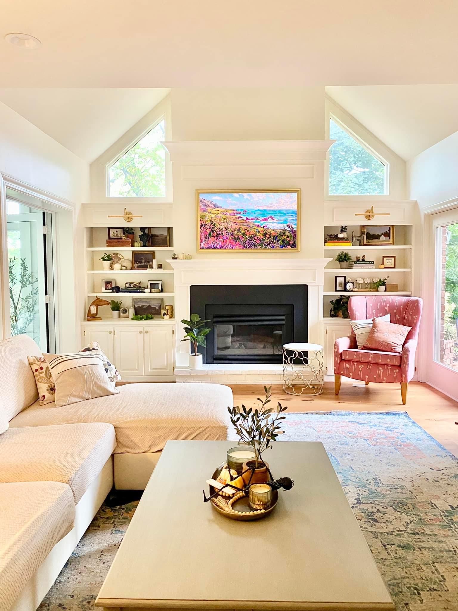 Living room with built-in shelves, fireplace, large sectional, arm chair, and a rug.