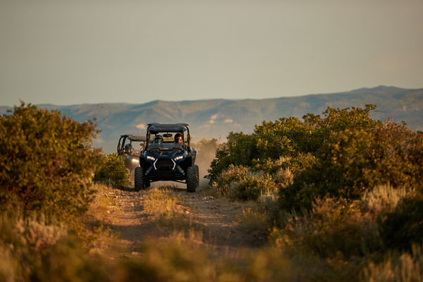 A person is riding a atv on a dirt road.