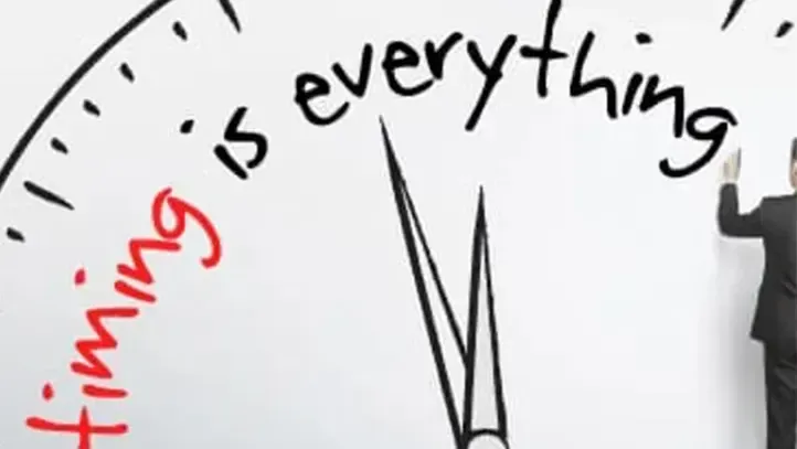 A person in a suit writes 