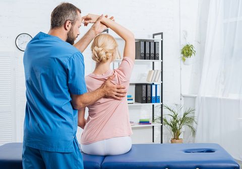 Physiotherapist Stretching Patients Arm — Pikeville, KY — Hackney & Hensley Chiropractic Center
