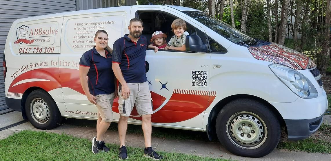 A Family is Standing in Front of a White Van — Abbsolve Services in Gympie, QLD