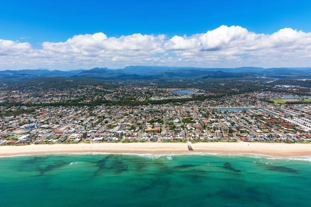 An Aerial View of a Beach With a City in the Background — Abbsolve Services in Palmview, QLD