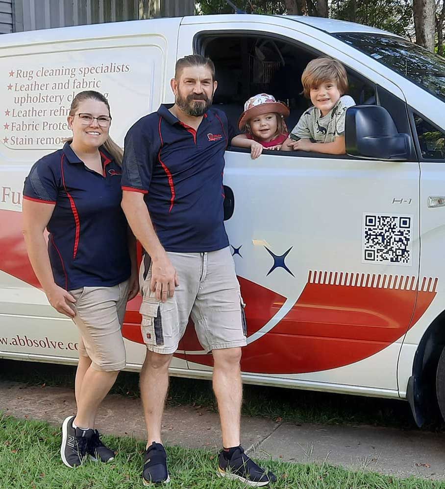 A Family is Posing for a Picture in Front of a Van — Abbsolve Services in Cooroy, QLD