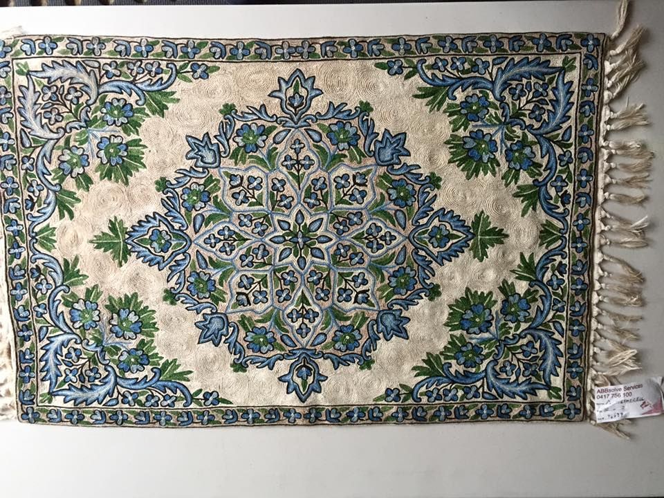 A Rug With a Blue and Green Pattern is Hanging on a Wall — Abbsolve Services in Cooroy, QLD
