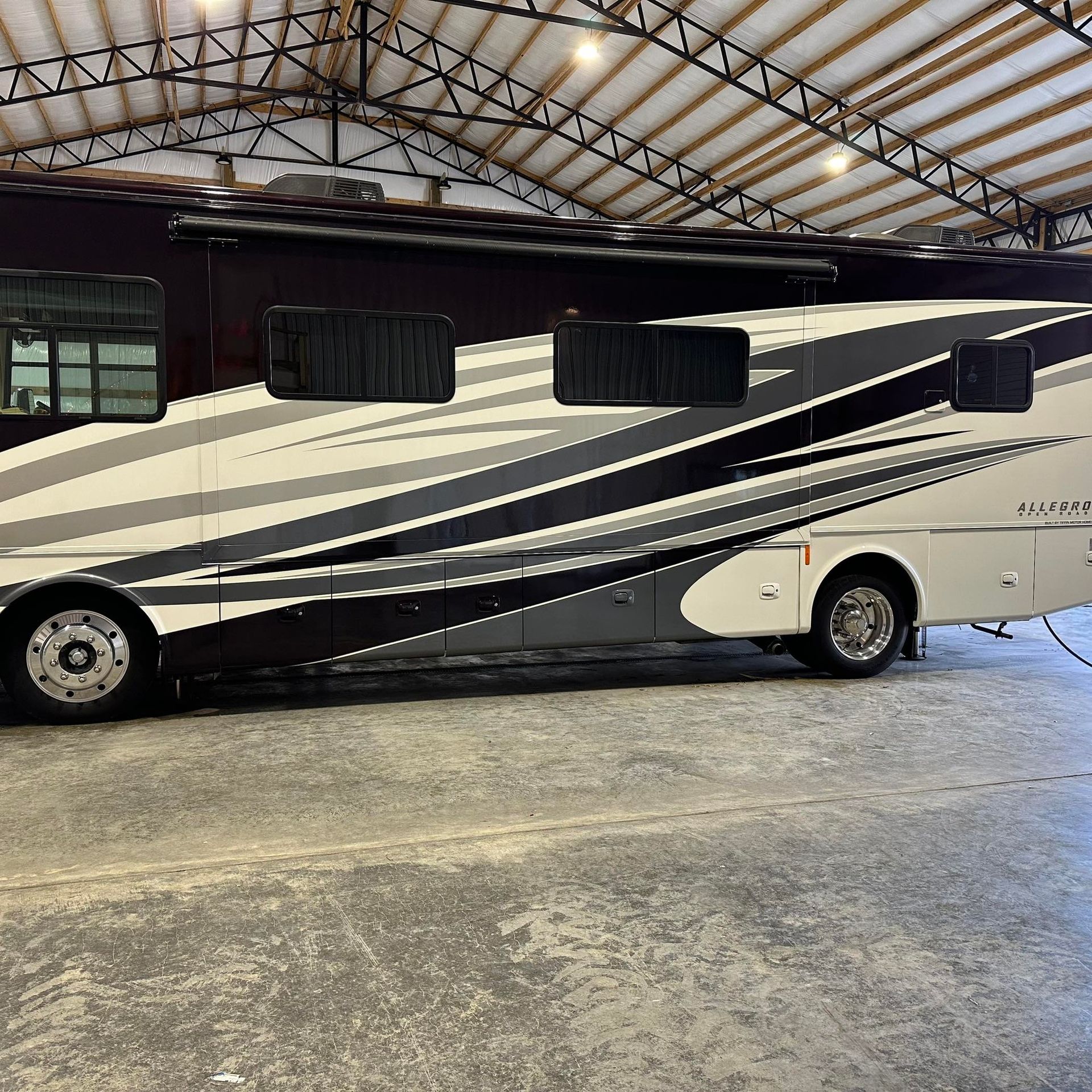 A large rv is parked in a warehouse.