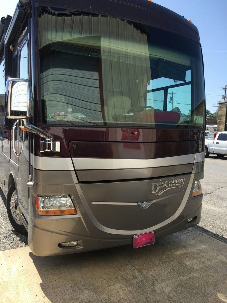 A large rv is parked in a parking lot.