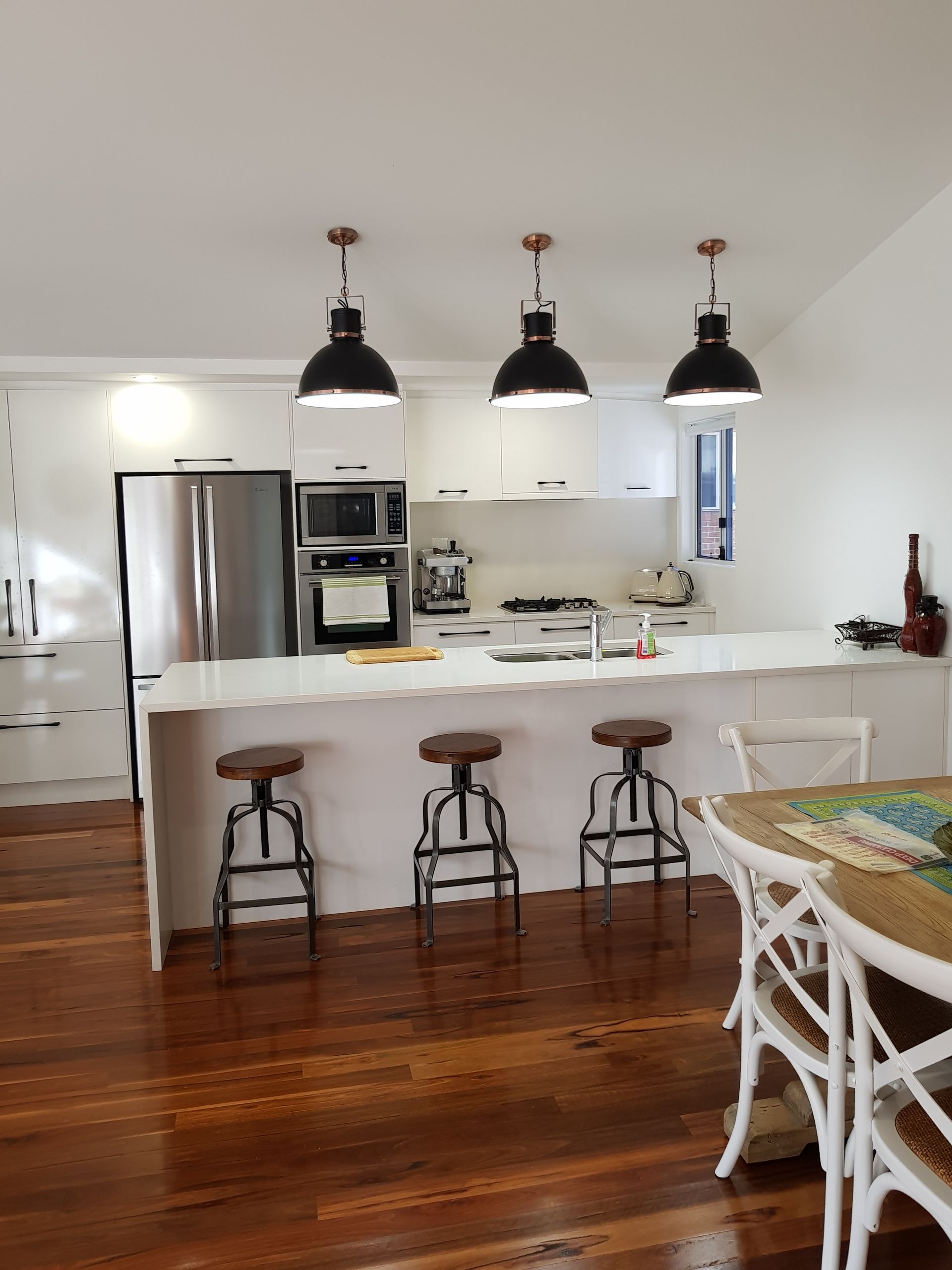 A Roof with Solar Panels and A Beach in The Background — Solar Electricians in Forster, NSW