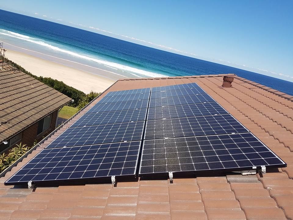 Solar Panels Installed on The Roof Overlooking The Beach — Forster Solar & Lighting In Forster, NSW