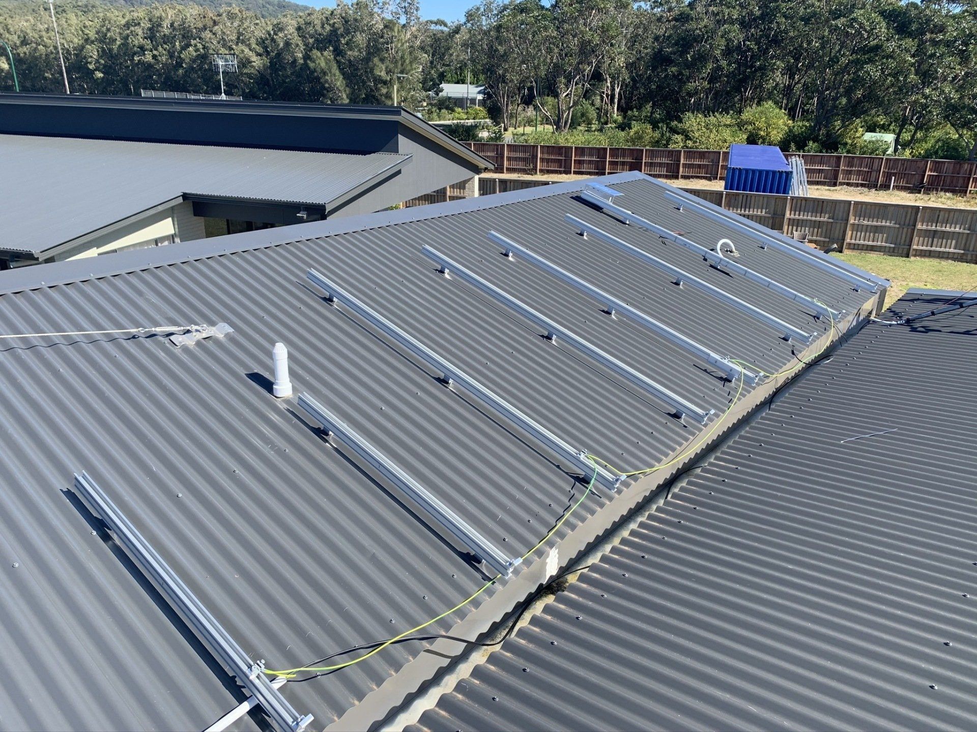 Electrician Installing Solar Panels On Roof — Solar Electricians in Forster, NSW