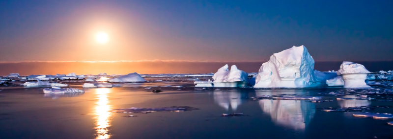 icebergs in the ocean at sunset