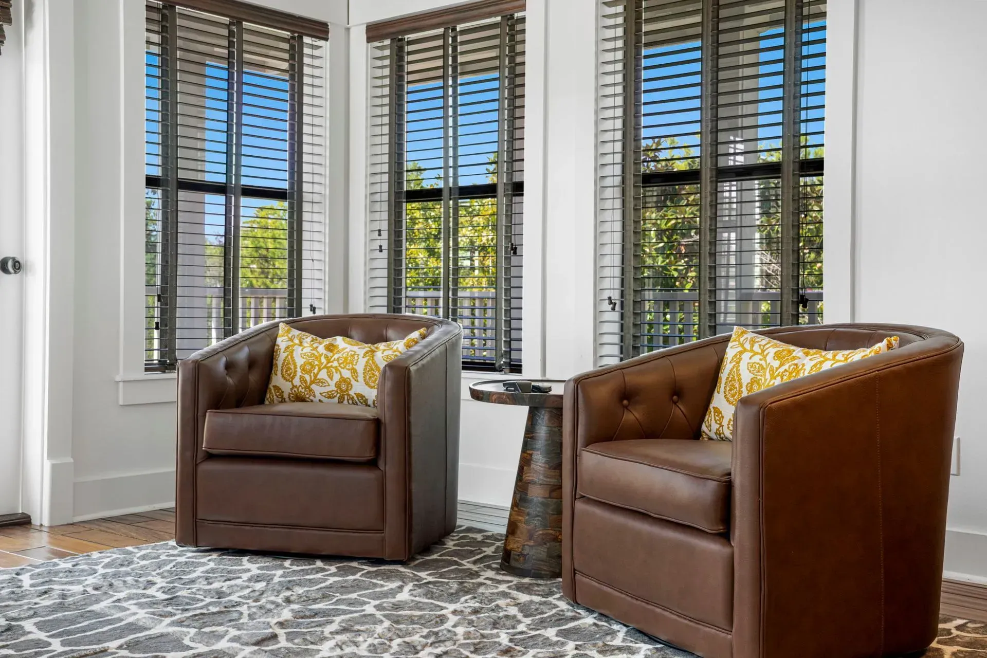 Sandy beach with clear, turquoise water, blue sky, and lush green foliage.