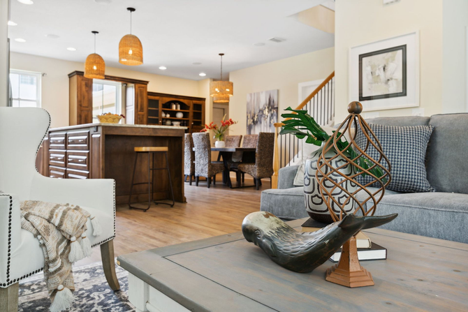 Open-concept living space with kitchen island, dining table, and living room seating.