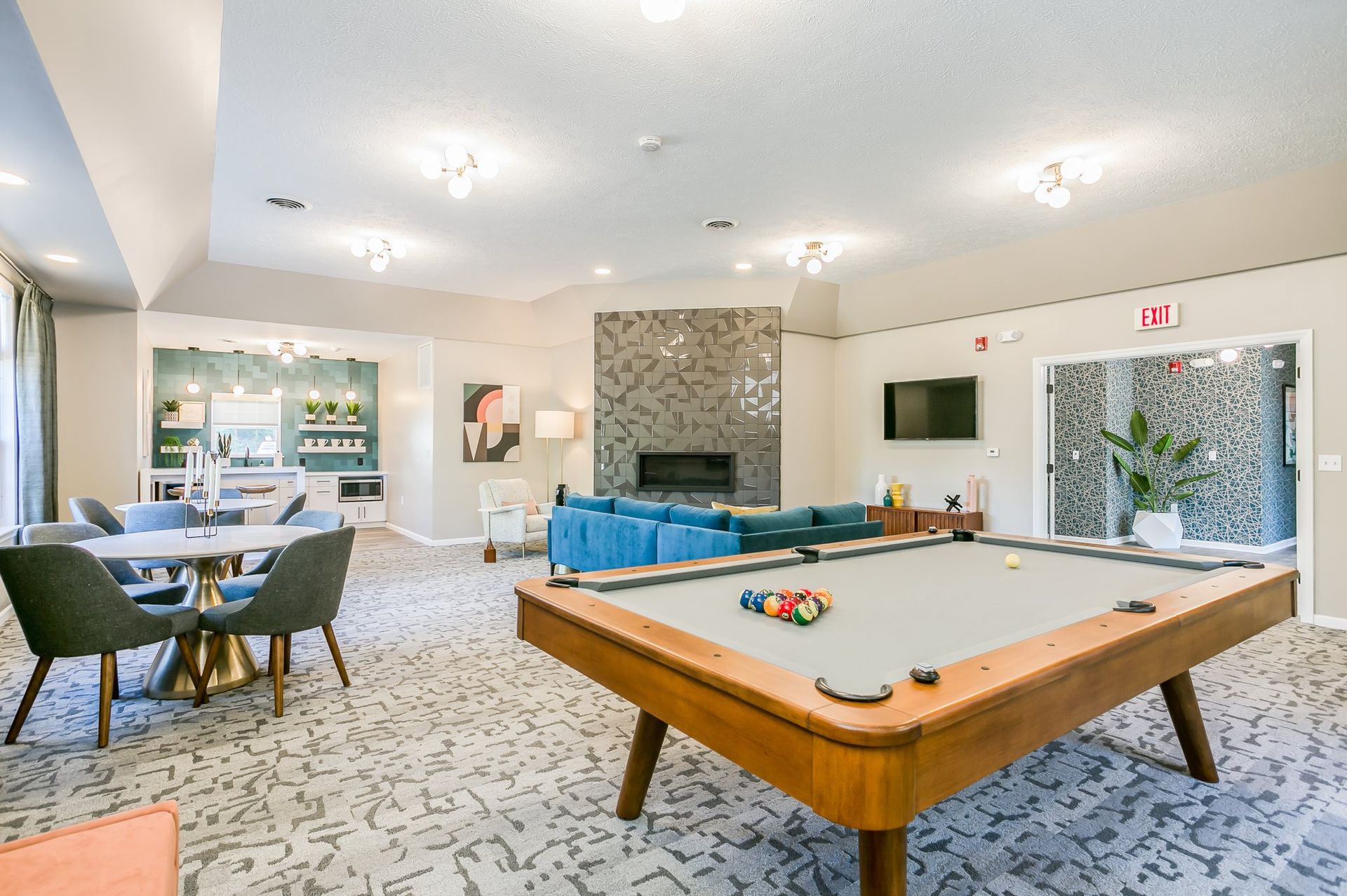 Community Room with Fireplace, Pool Table, and Kitchen