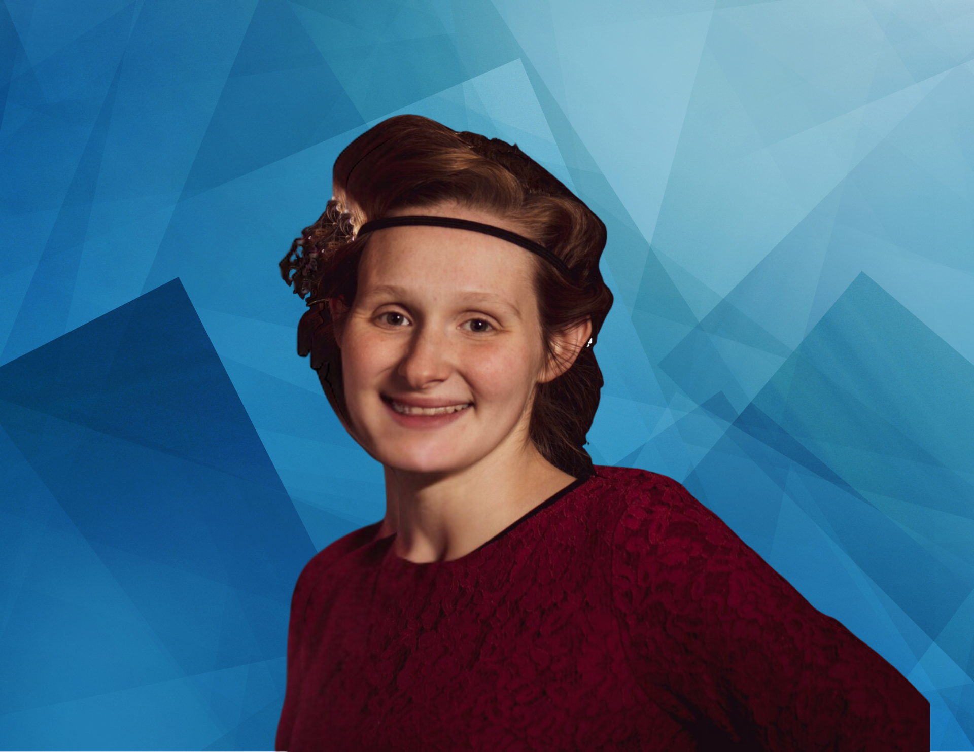 A young woman wearing a red sweater and a headband is standing in front of a blue background.