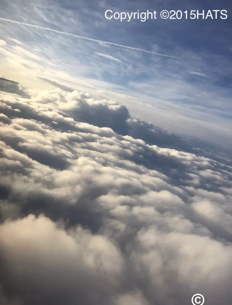 A picture of clouds taken from an airplane window