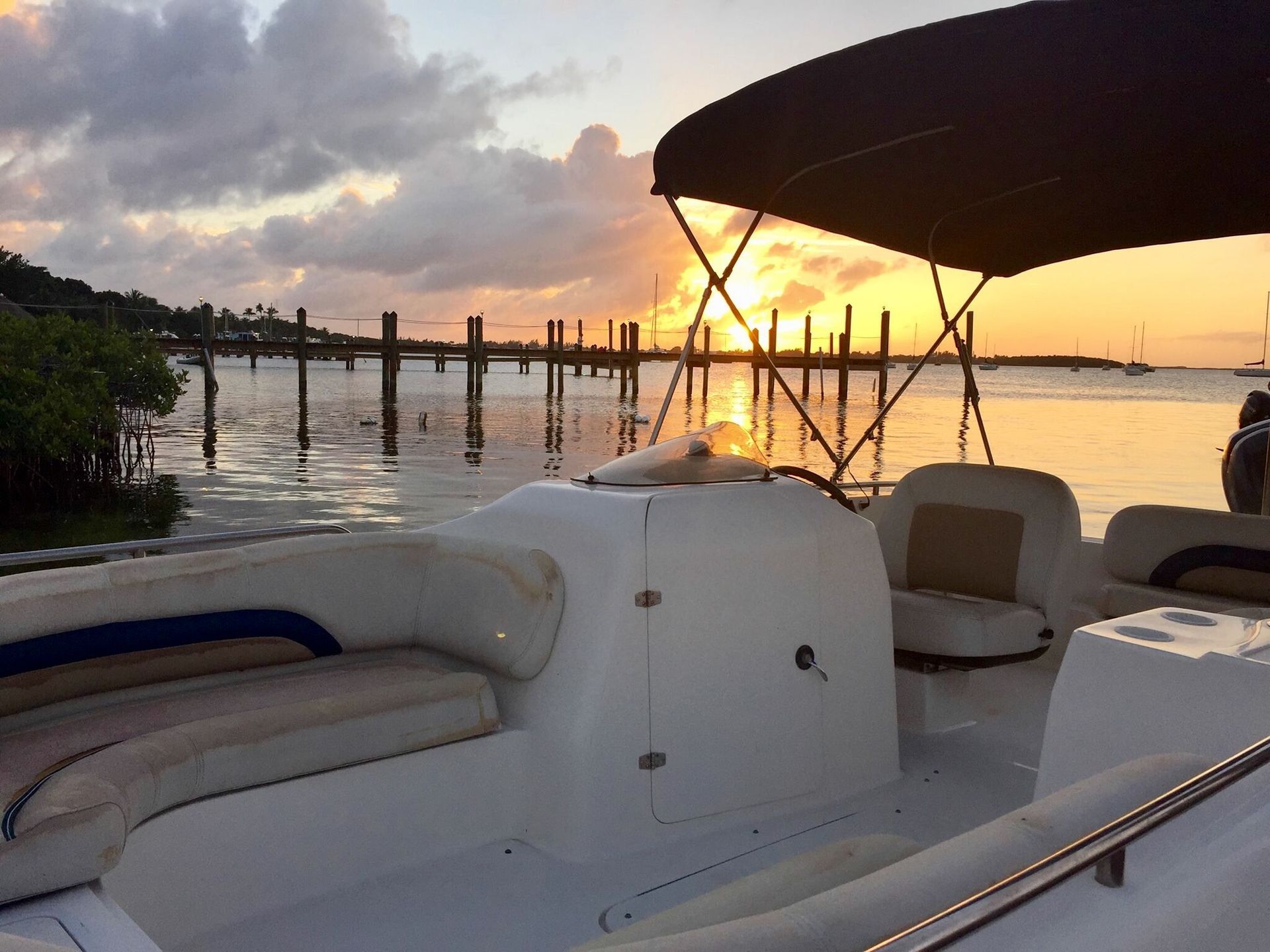 A boat in the water with a sunset in the background