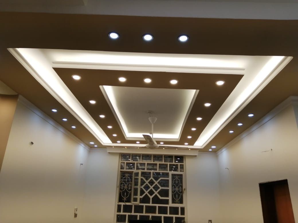 A living room with a ceiling fan and a brick wall