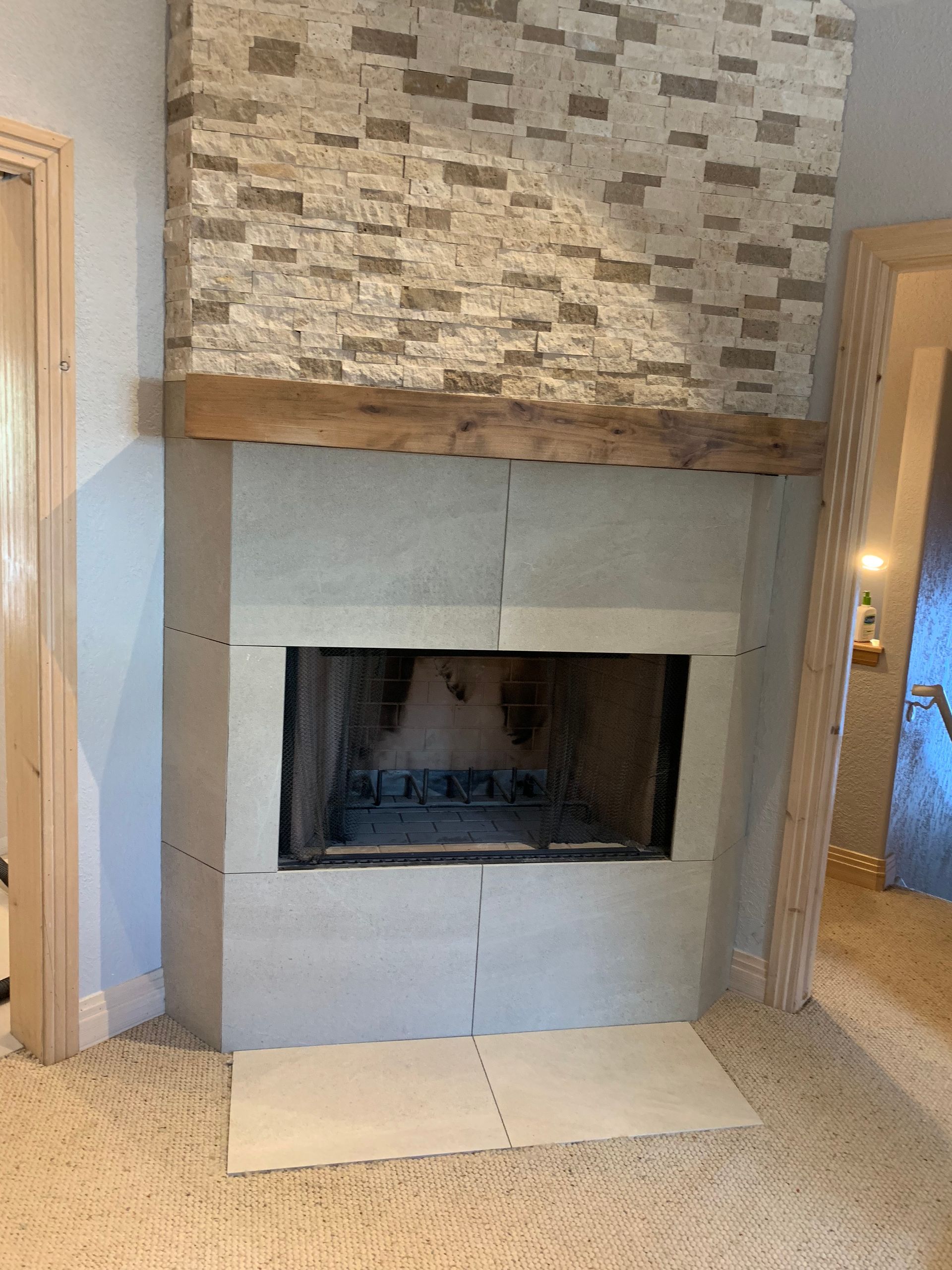 There is a fireplace in the corner of the room.