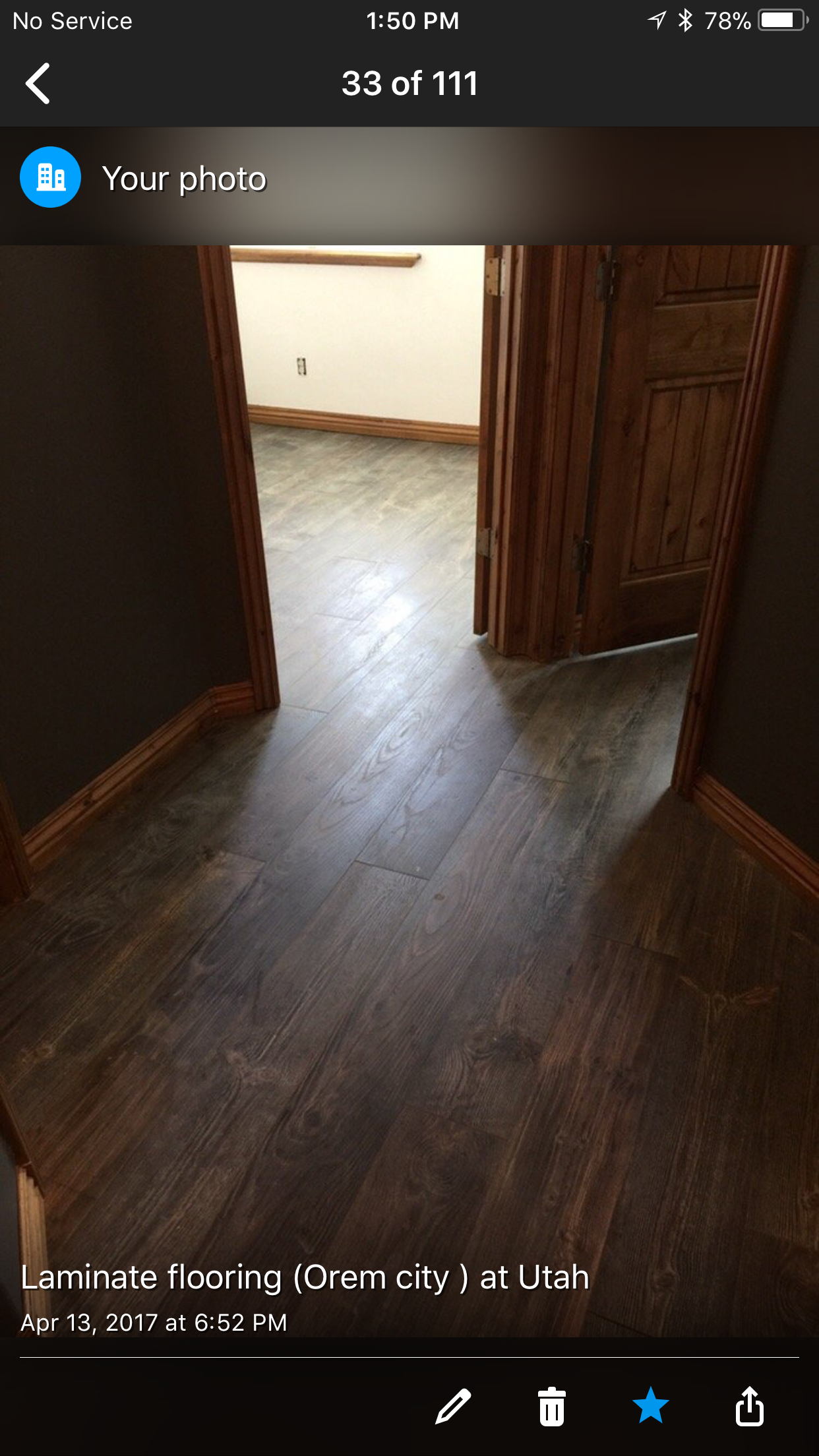 A picture of a room with a wooden floor and a door.