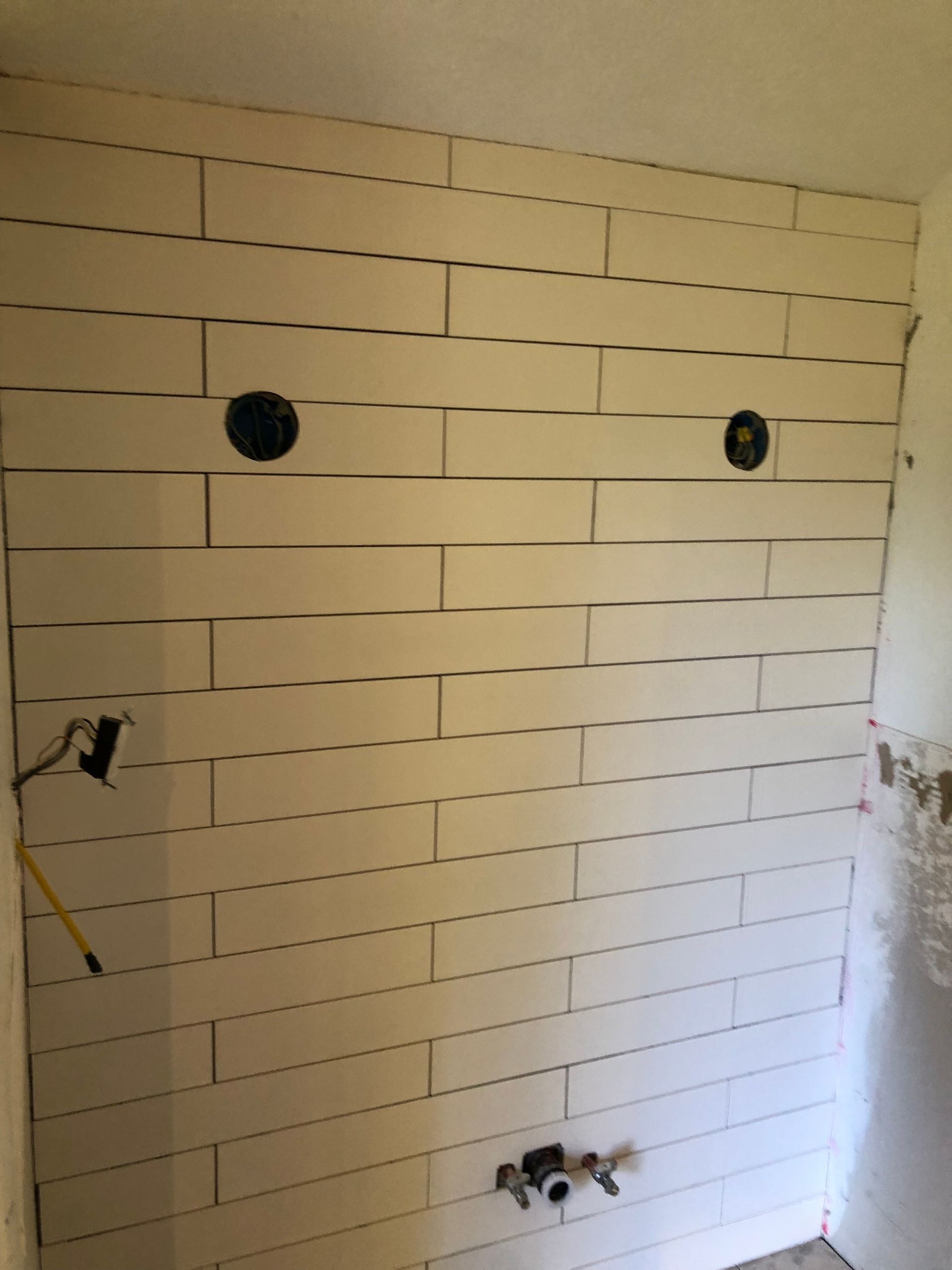 A white brick wall with two holes in it
