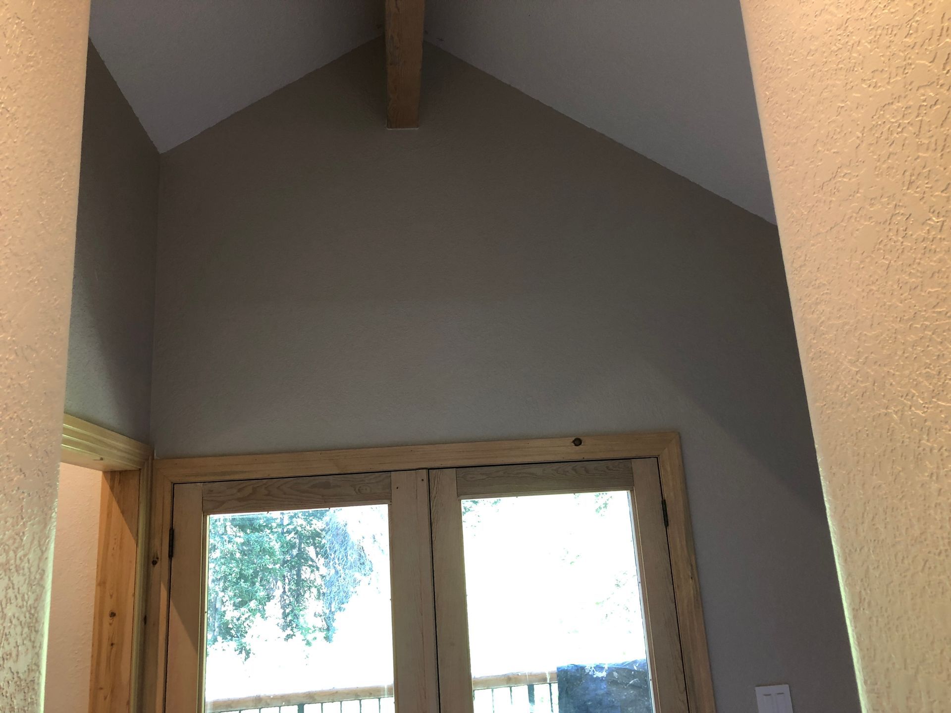 A window in a room with a vaulted ceiling
