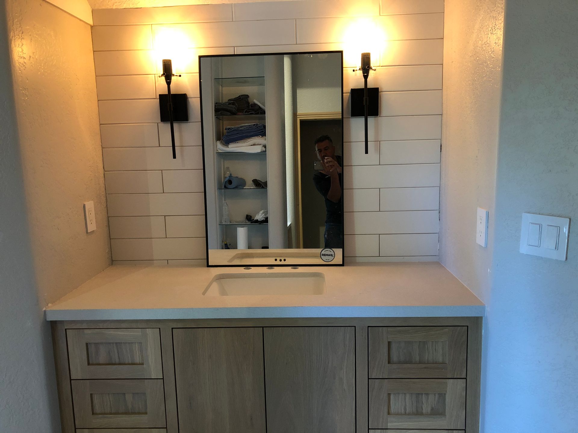A bathroom with a sink and a mirror.