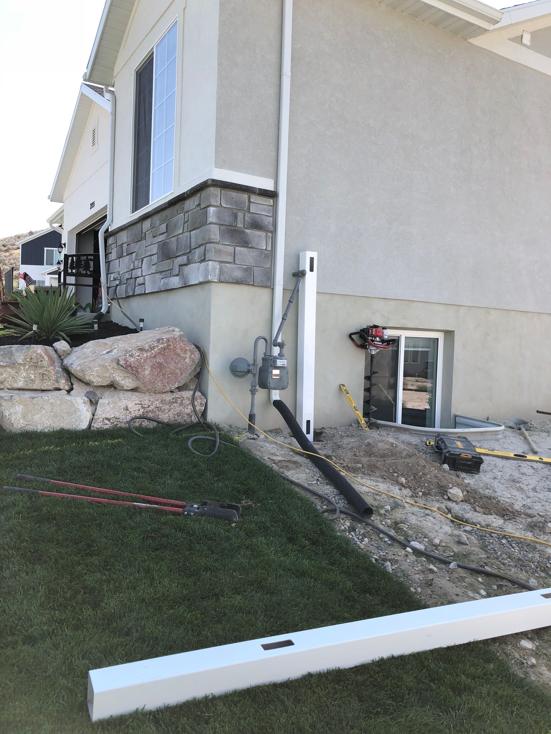 A house that is being remodeled with a lot of tools on the ground