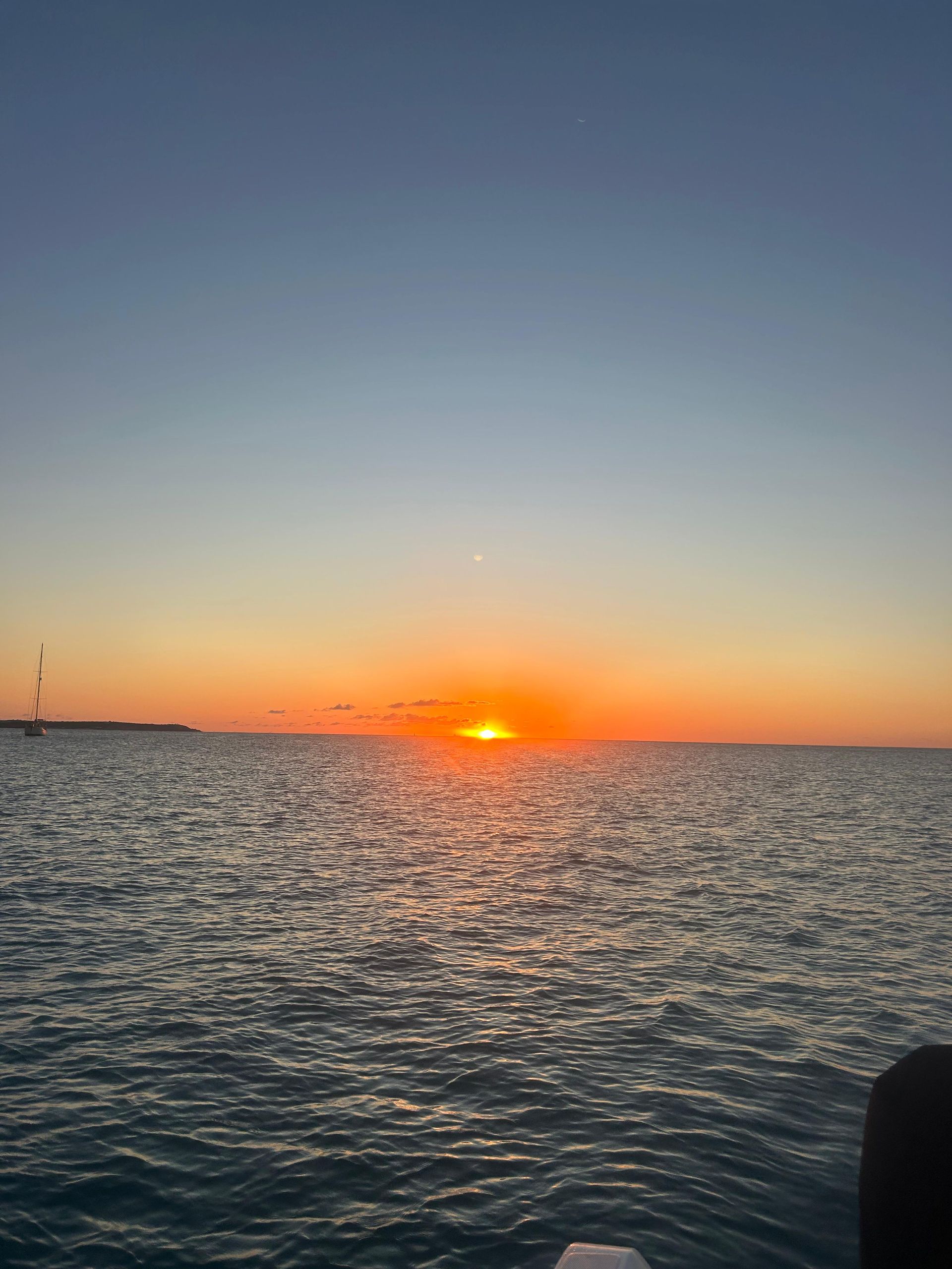Sunset over the ocean with shades of orange and blue.