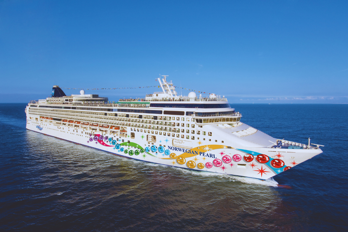Cruise ship, Norwegian, sailing on a blue ocean under a clear sky, colorful painted hull.