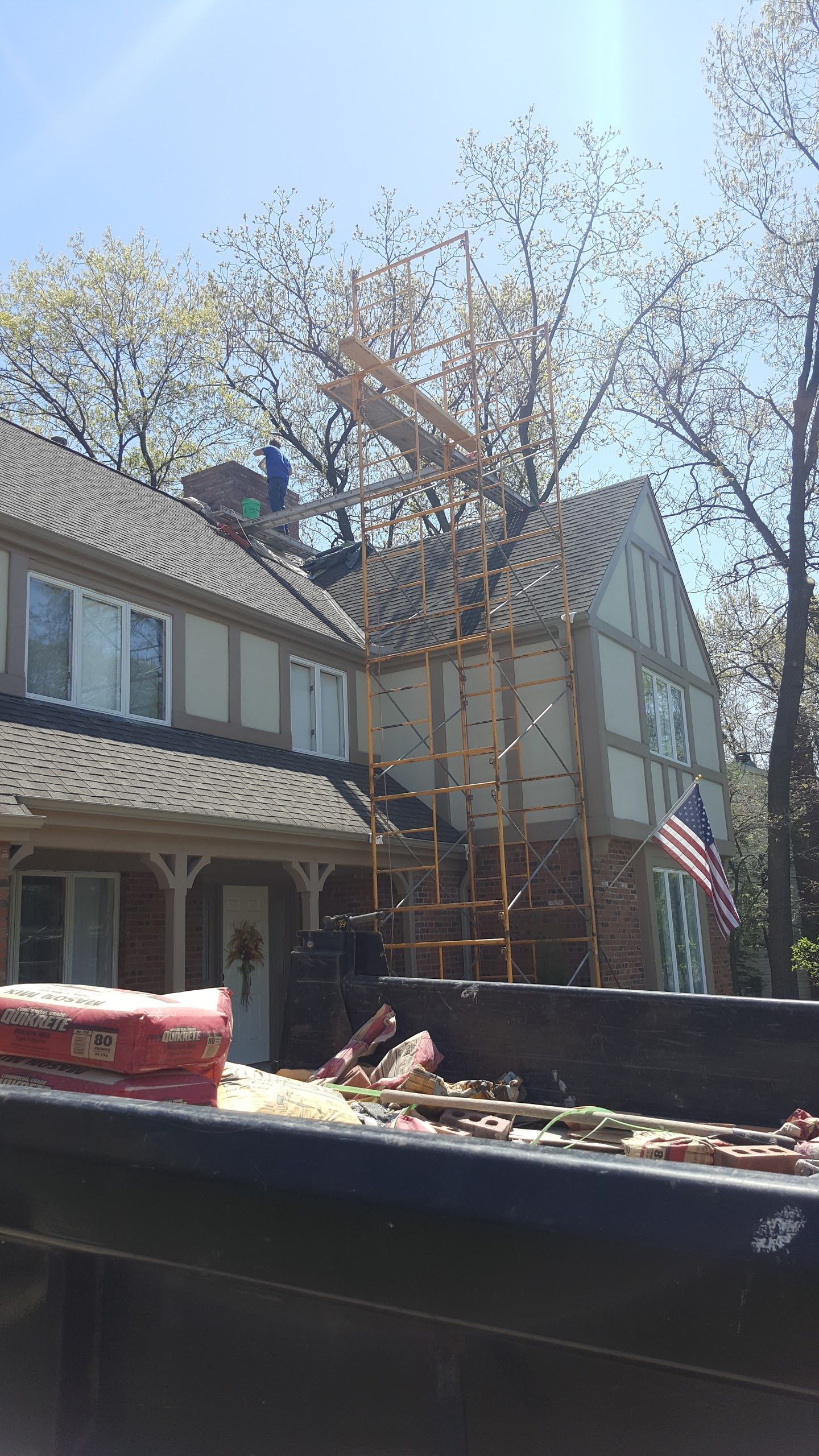 A truck is parked in front of a house under construction.