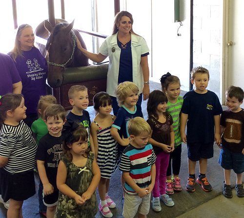 A Group Of Kids Taking A Photo In Front Of A Horse – Stephenville, TX – Ark Veterinary Hospital