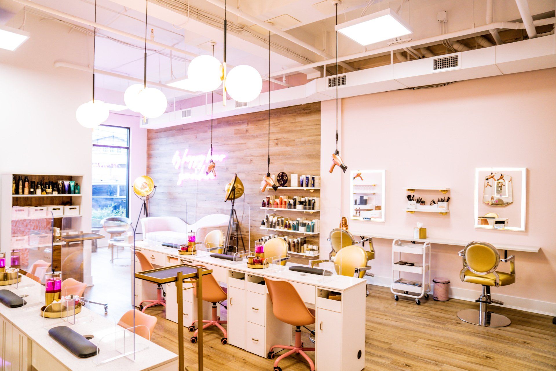 A nail salon with a lot of tables and chairs.