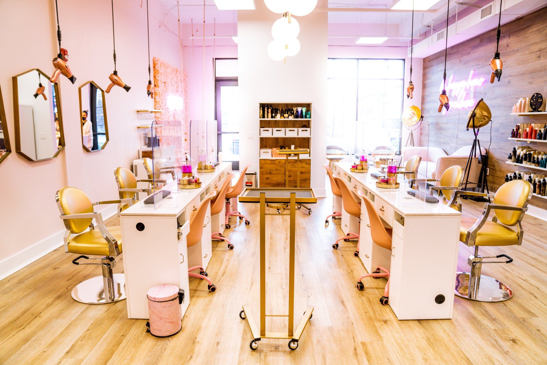 A salon with a lot of tables and chairs in it.
