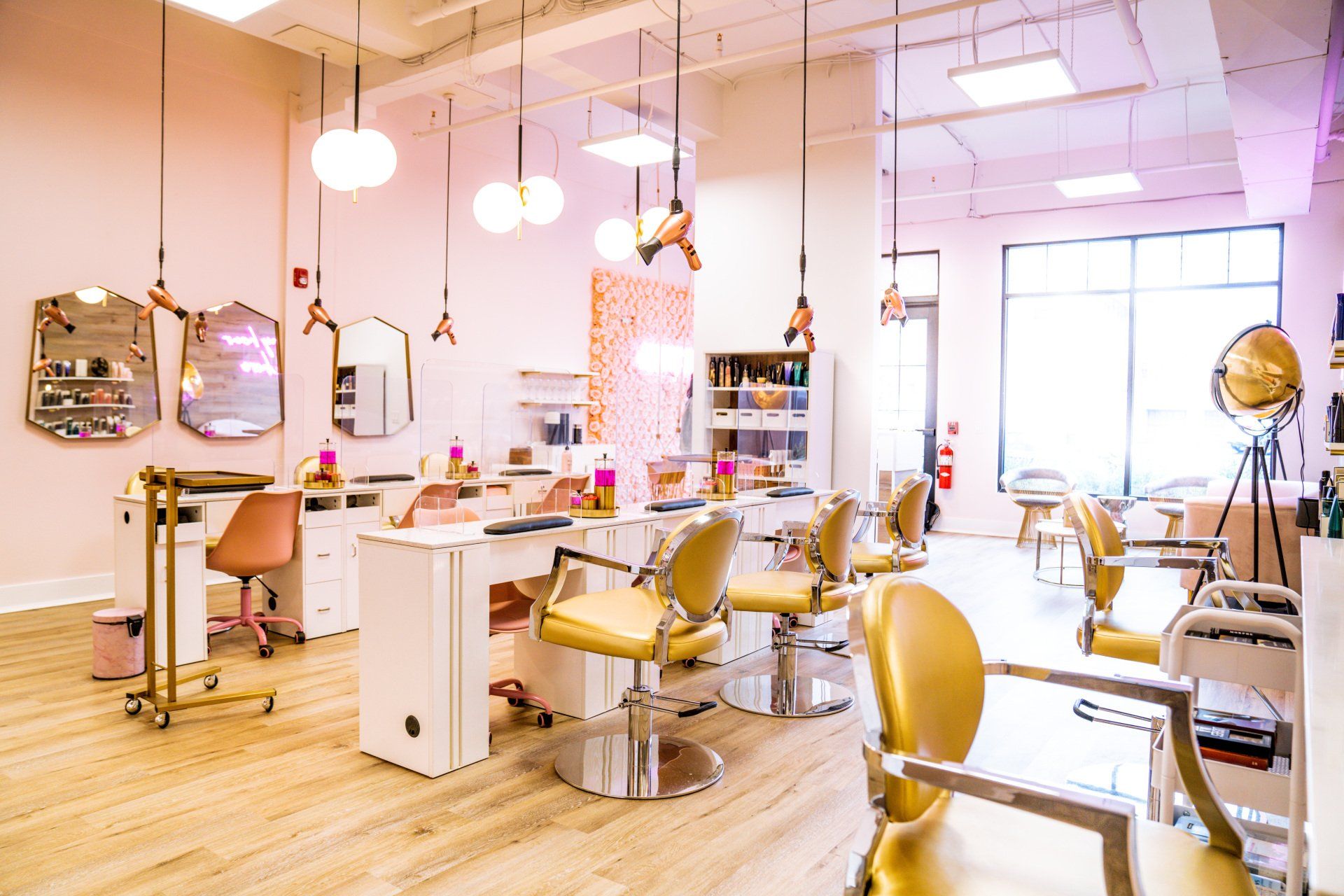 A hair salon with a lot of chairs and tables.