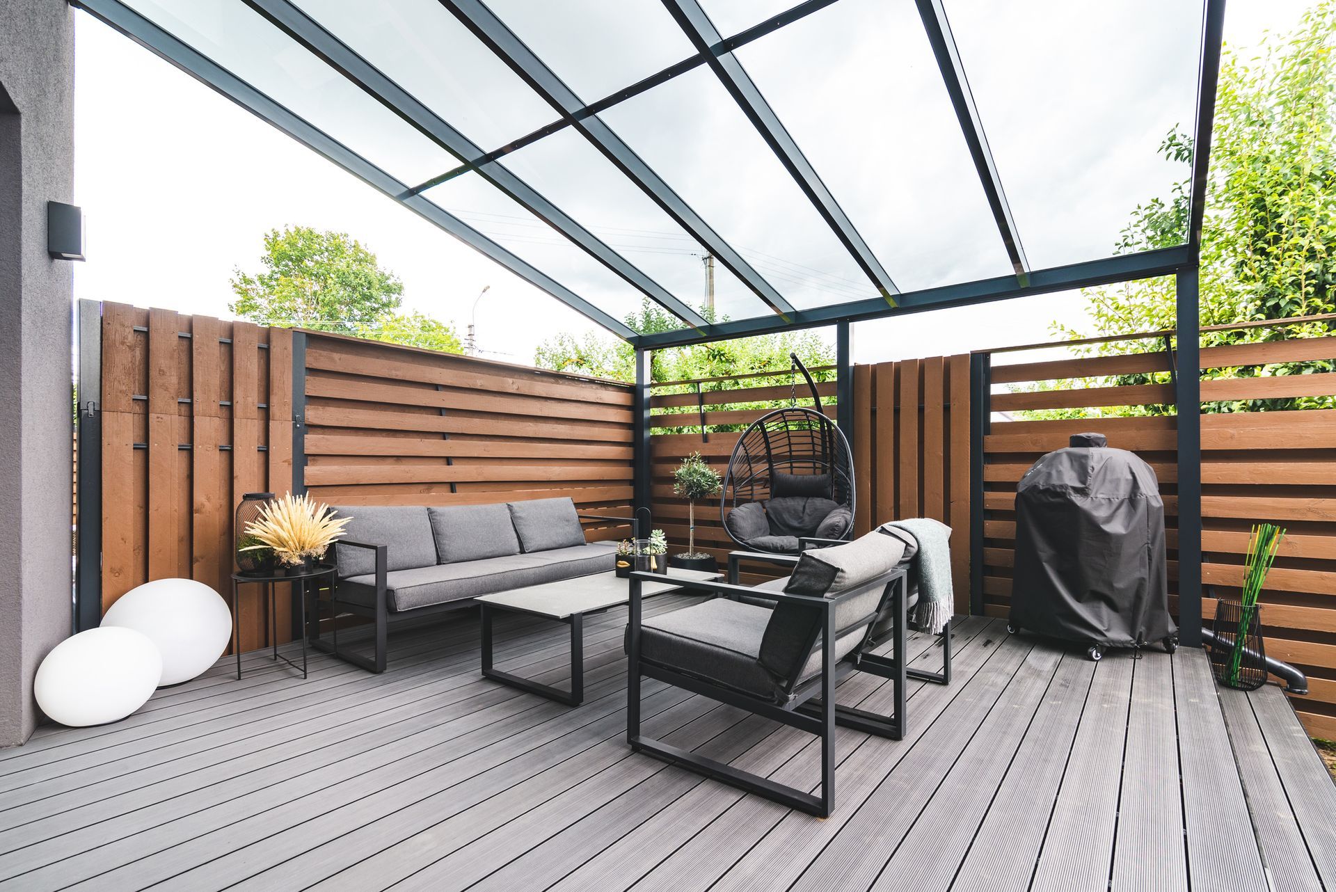A patio with a pergola and a fireplace in the backyard.
