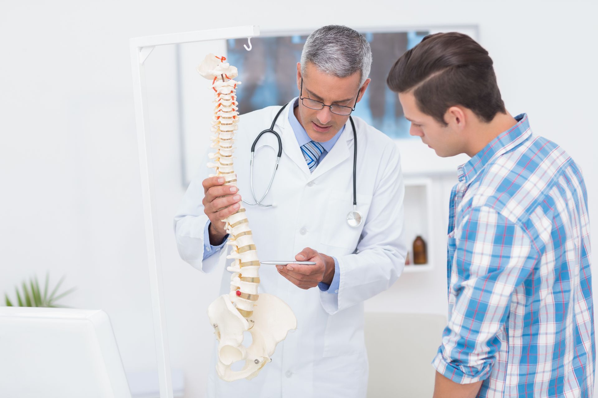 doctor explaining spine structure to a patient