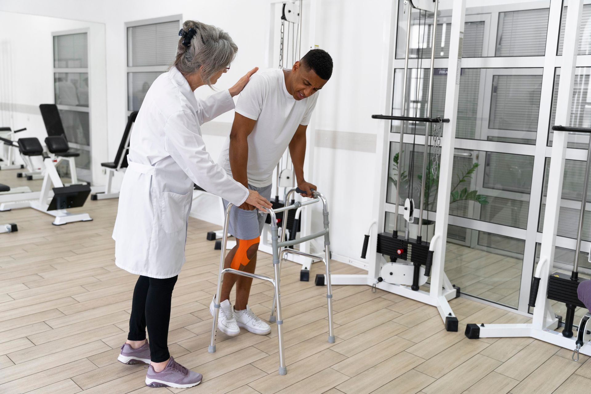 a man with a knee brace is using a walker