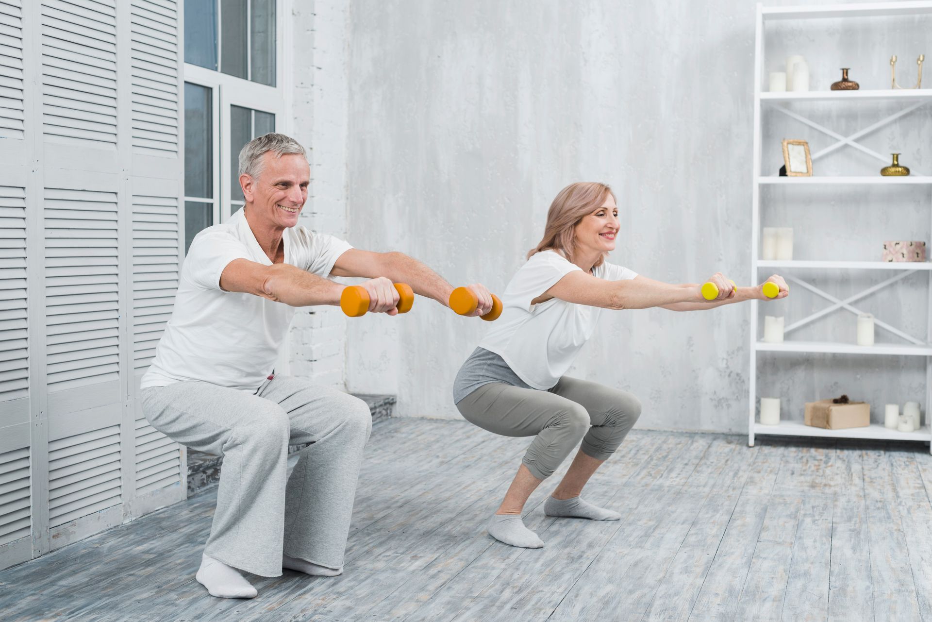 an old couple doing squats with weights