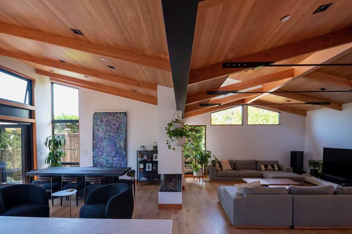 A living room with a lot of furniture and a wooden ceiling.
