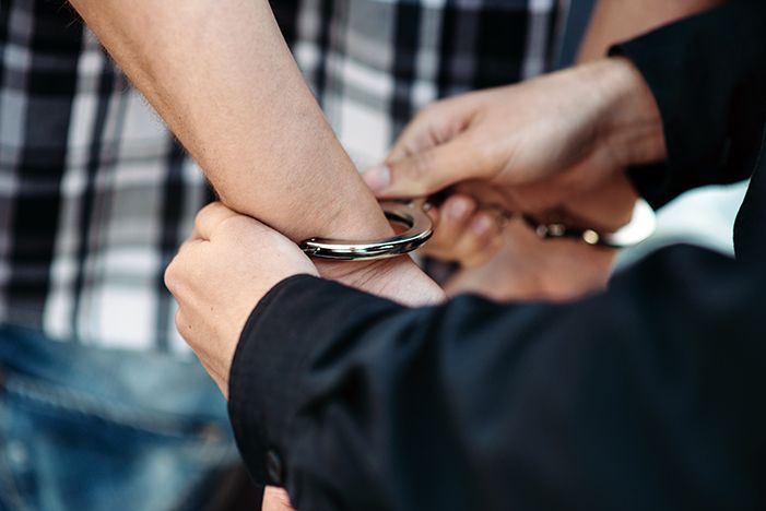 A male driver suspected of driving while intoxicated getting arrested.